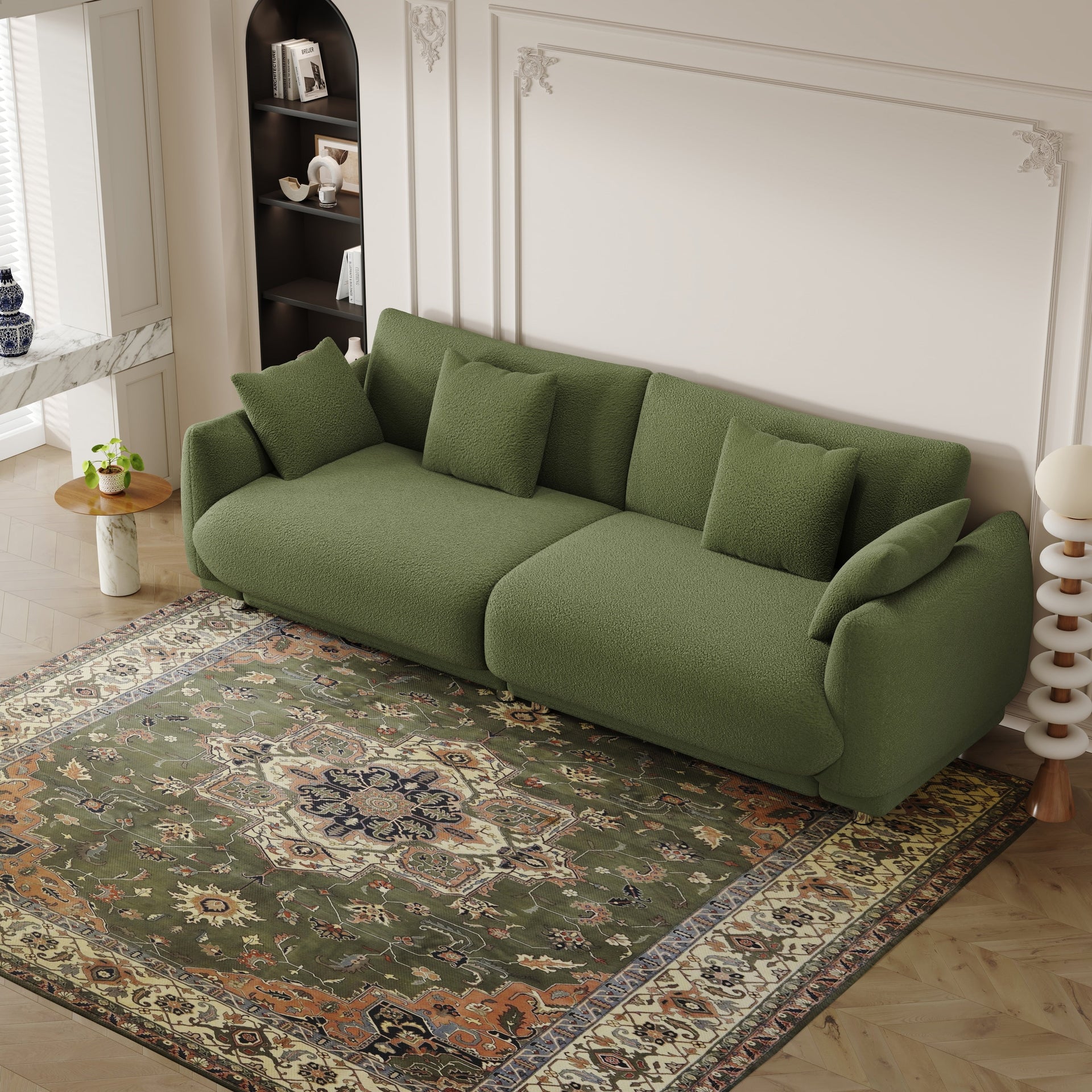 An 86.6-inch teddy wool green sofa with four throw pillows and hardware feet that can sit comfortably in an apartment bedroom wi