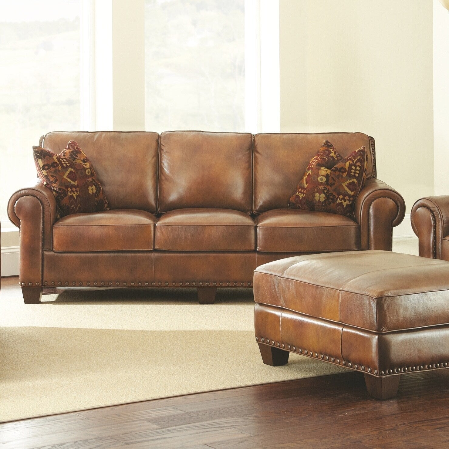 Steve Silver Sanremo Top Grain Leather Sofa with Nail Head Trim and Decorative Pillows